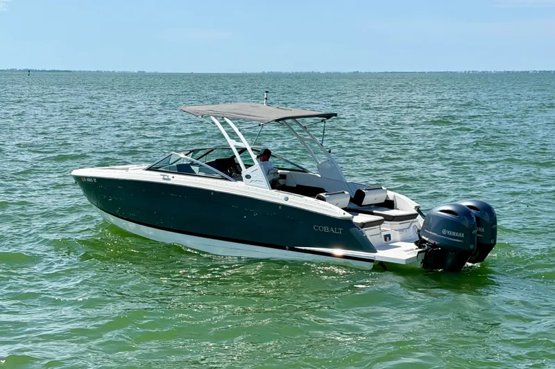 Slide: The Image of 2022 Cobalt R8 Outboard boat on calm green water, featuring dual Yamaha engines. - 11