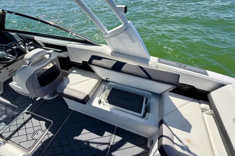 Slide: The Image of 2022 Cobalt R8 Outboard boat interior with seating and storage, on water. - 32