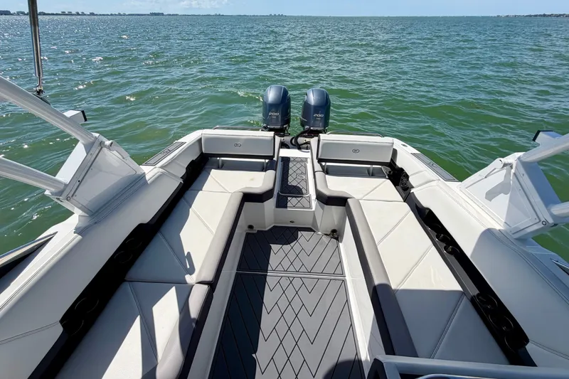 Slide: The Image of 2022 Cobalt R8 Outboard boat interior with dual engines on open water. - 15