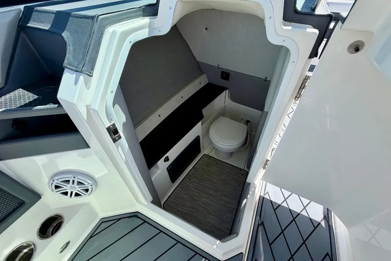 Slide: The Image of 2022 Cobalt R8 Outboard boat interior with compact bathroom and modern amenities. - 29
