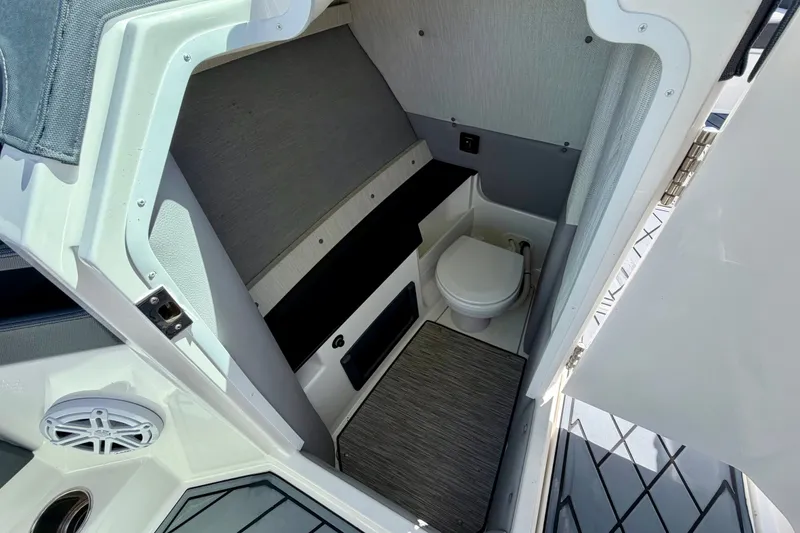 Slide: The Image of 2022 Cobalt R8 Outboard boat interior with compact bathroom and modern design. - 30