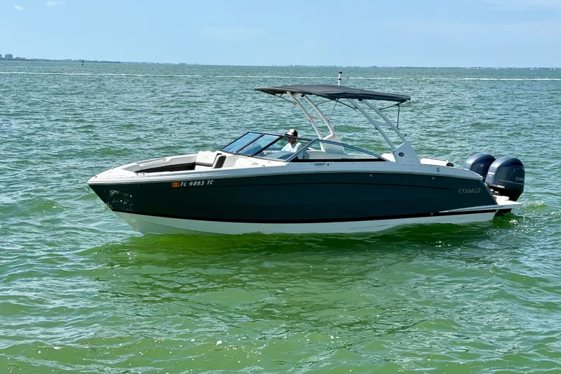 Slide: The Image of 2022 Cobalt R8 Outboard boat cruising on clear blue water. - 9