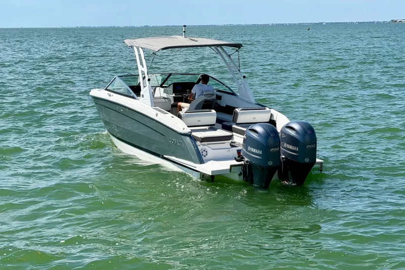 Slide: The Image of 2022 Cobalt R8 Outboard boat with twin Yamaha engines cruising on open water. - 2