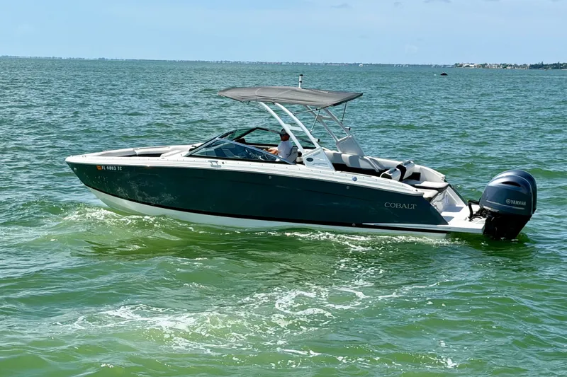 Slide: The Image of 2022 Cobalt R8 Outboard boat cruising on open water under clear skies. - 6