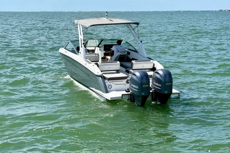 Slide: The Image of 2022 Cobalt R8 Outboard boat cruising on open water with dual Yamaha engines. - 10