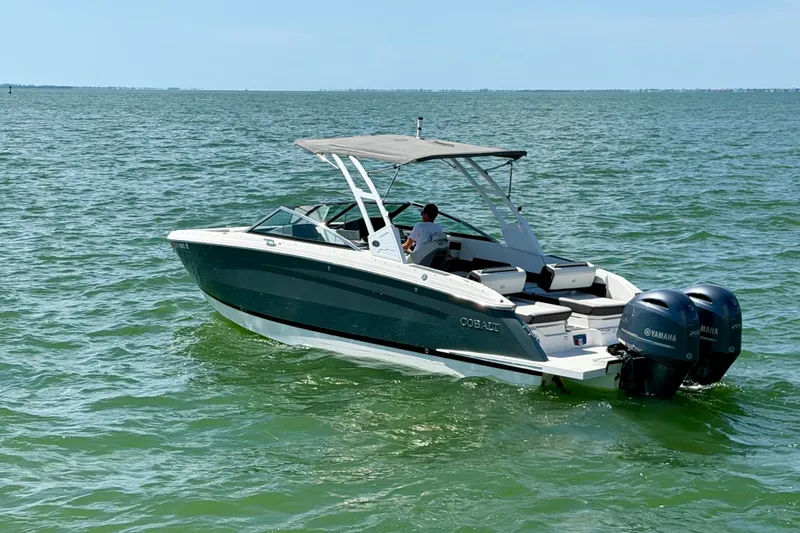 The Image of 2022 Cobalt R8 Outboard boat cruising on open water with dual Yamaha engines. - 1