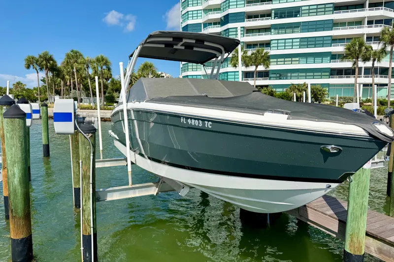 Slide: The Image of 2022 Cobalt R8 Outboard boat docked near waterfront building and palm trees. - 36