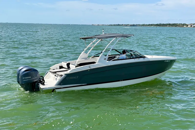 Slide: The Image of 2022 Cobalt R8 Outboard boat cruising on clear green water. - 5