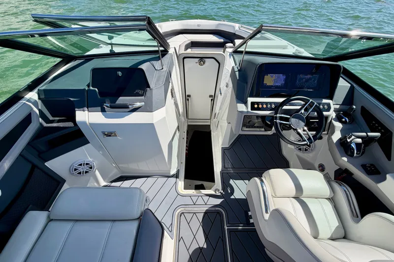 Slide: The Image of 2022 Cobalt R8 Outboard boat interior with modern dashboard and seating on water. - 31