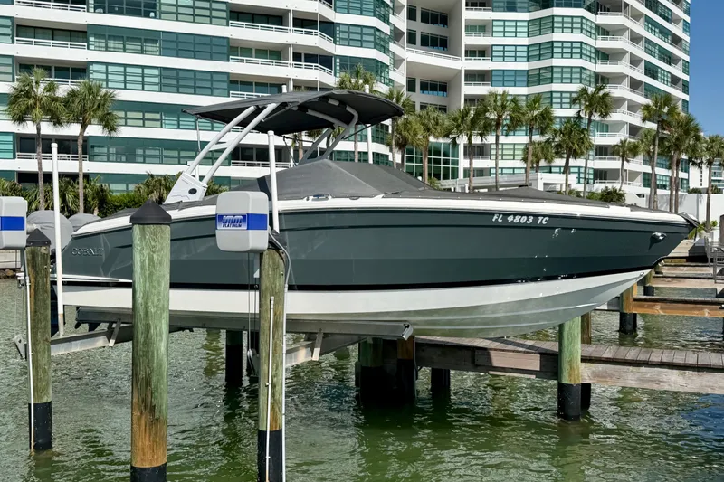Slide: The Image of 2022 Cobalt R8 Outboard boat docked near modern waterfront buildings. - 40