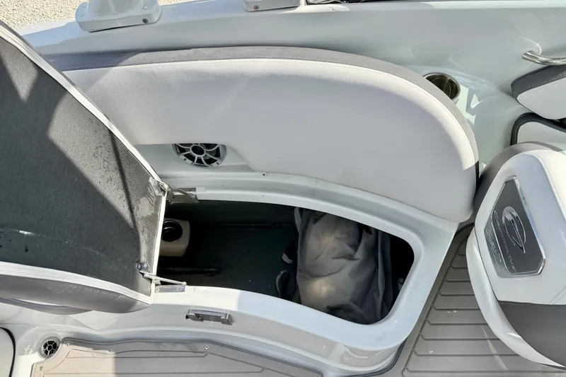 Slide: The Image of 2024 Crownline Eclipse E285 XS boat storage compartment with open hatch and visible interior. - 31