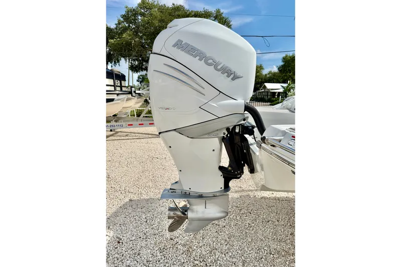 Slide: The Image of 2024 Crownline Eclipse E285 XS with Mercury outboard engine, displayed outdoors. - 24