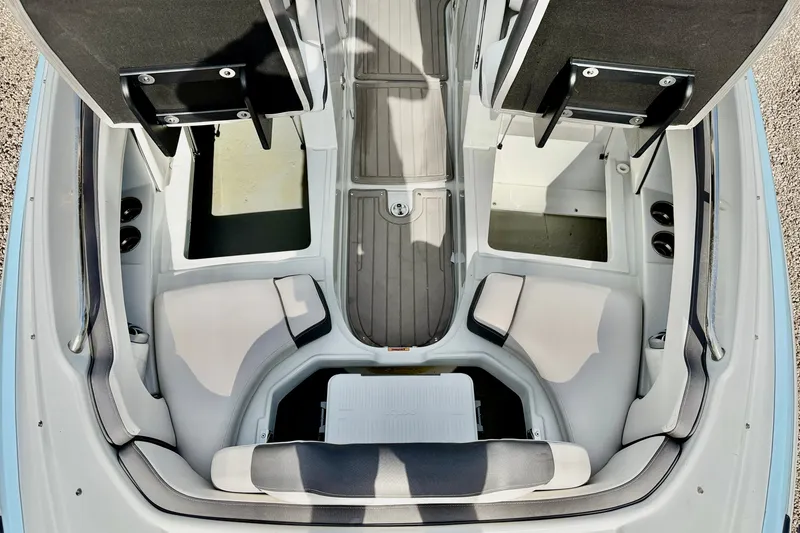 Slide: The Image of 2024 Crownline Eclipse E285 XS boat interior with seating and storage compartments. - 21