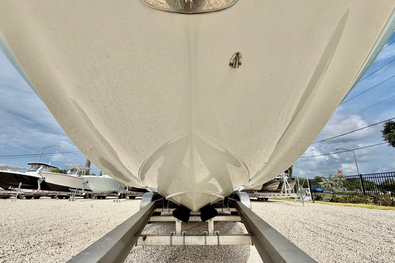 Slide: The Image of 2024 Crownline Eclipse E285 XS boat hull on trailer, outdoor display. - 22