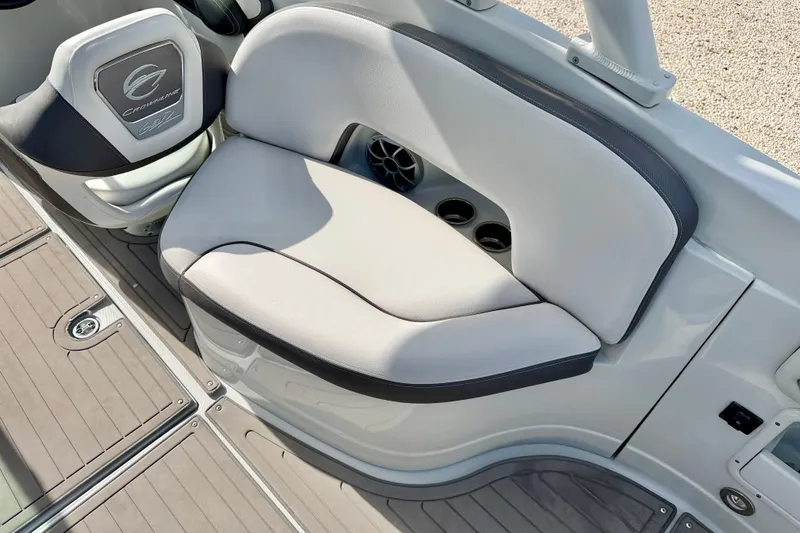 Slide: The Image of 2024 Crownline Eclipse E285 XS boat seating area with cup holders and speaker. - 15