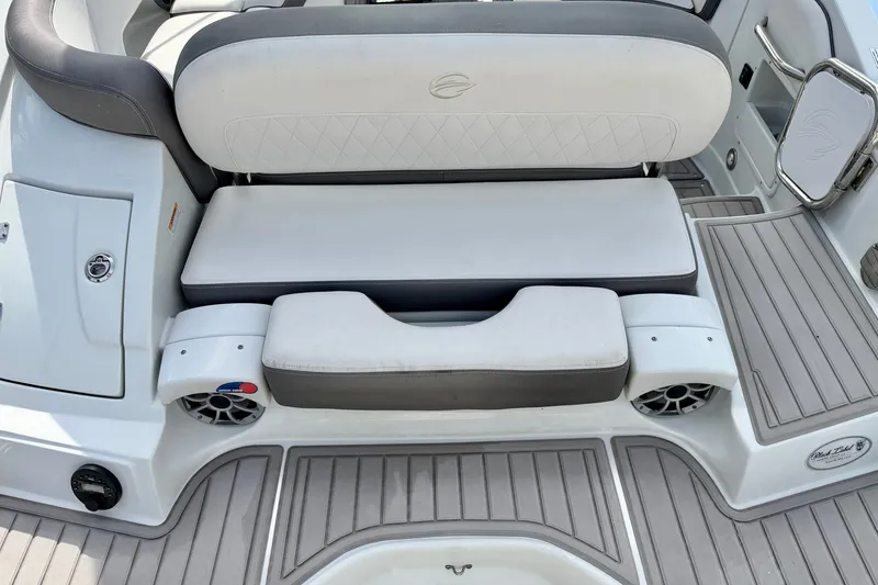 Slide: The Image of 2024 Crownline Eclipse E285 XS boat seating area with premium upholstery and integrated speakers. - 18