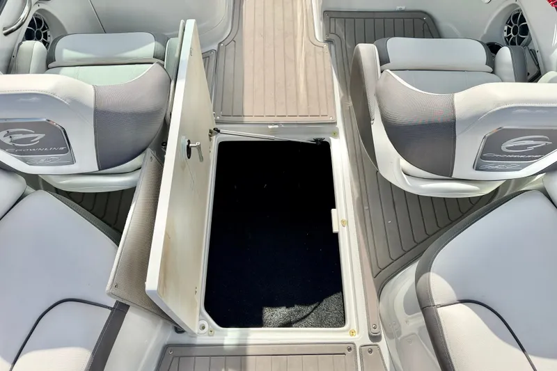 Slide: The Image of 2024 Crownline Eclipse E285 XS boat interior with open storage compartment. - 28