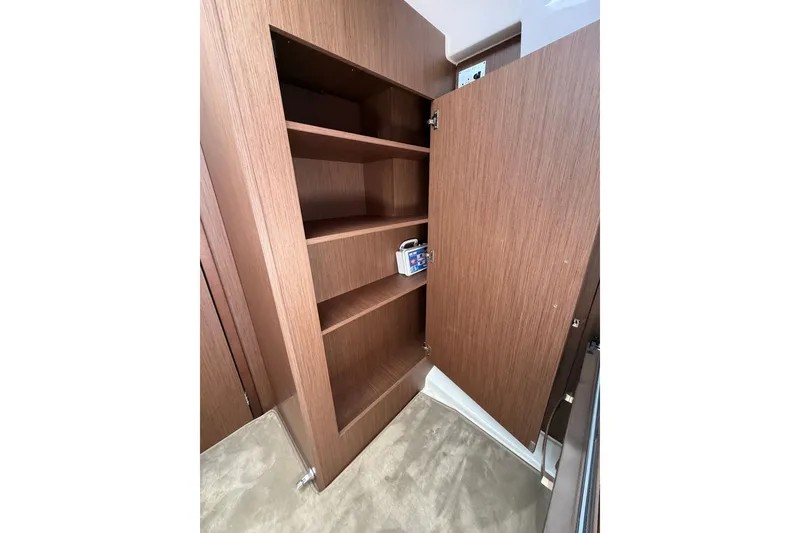 Slide: The Image of Wooden storage cabinet with open shelves inside a 2023 Beneteau Antares 11 OB boat. - 68