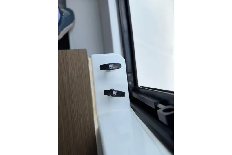 Slide: The Image of Interior detail of 2023 Beneteau Antares 11 OB boat, featuring window latches. - 46