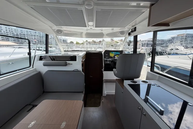 Slide: The Image of Interior of 2023 Beneteau Antares 11 OB, featuring modern helm and seating area. - 91