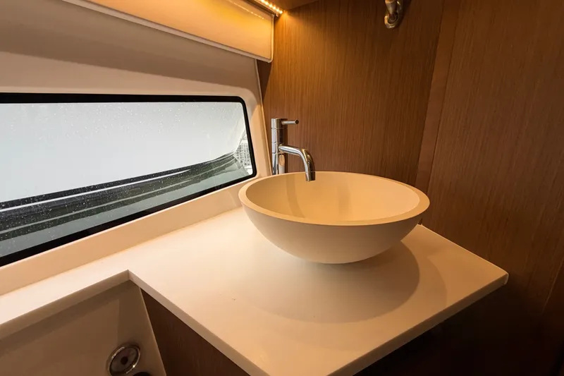 Slide: The Image of Modern bathroom sink in 2023 Beneteau Antares 11 OB yacht, featuring sleek design and wood accents. - 51