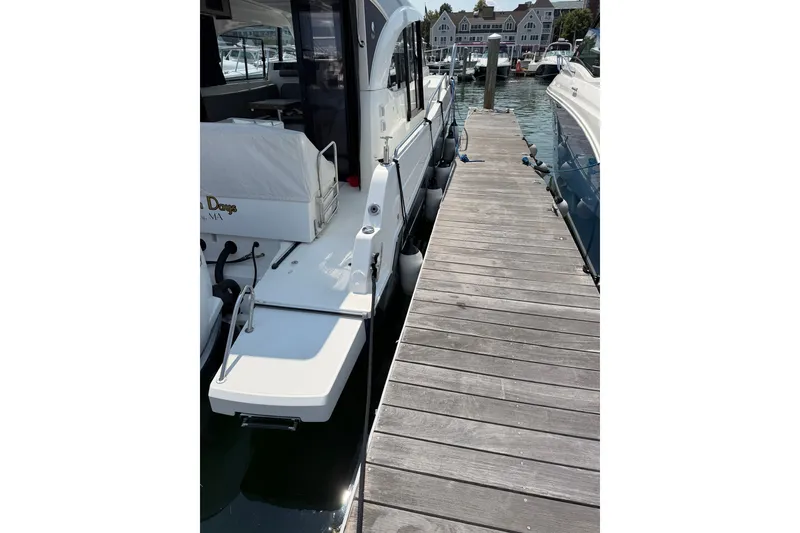 Slide: The Image of 2023 Beneteau Antares 11 OB docked at a marina, side view. - 9