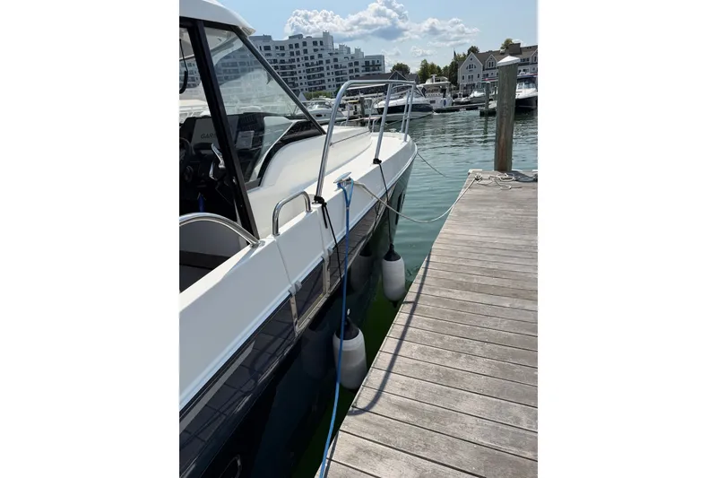 Slide: The Image of 2023 Beneteau Antares 11 OB docked at marina, side view with fenders. - 6