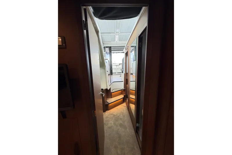 Slide: The Image of Interior view of 2023 Beneteau Antares 11 OB yacht, featuring a narrow hallway and modern design. - 57