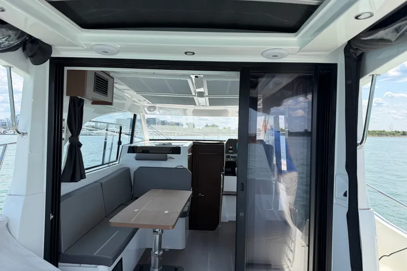 Slide: The Image of Interior view of 2023 Beneteau Antares 11 OB boat with seating and table. - 22