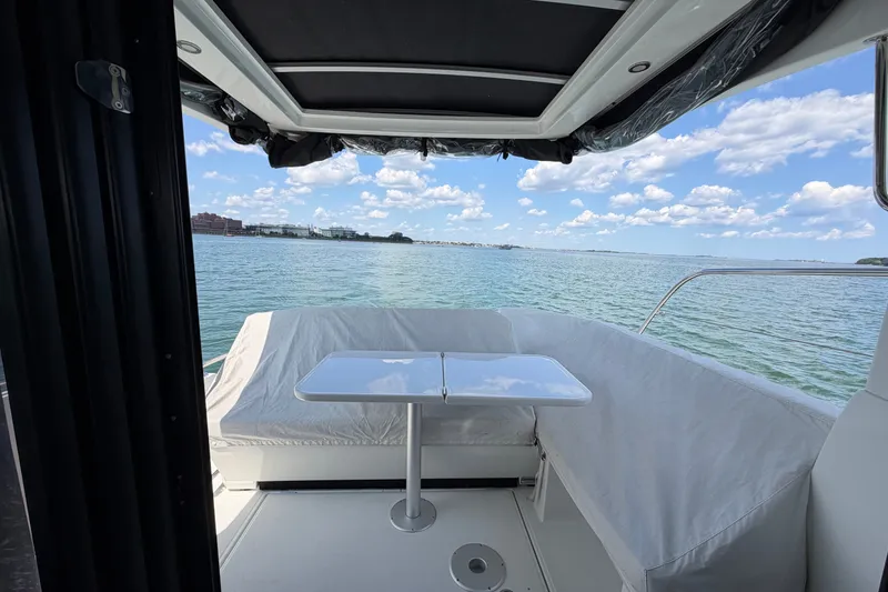Slide: The Image of Interior view of 2023 Beneteau Antares 11 OB boat with ocean backdrop. - 23
