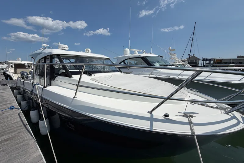 Slide: The Image of 2023 Beneteau Antares 11 OB docked, showcasing sleek design and modern features. - 13
