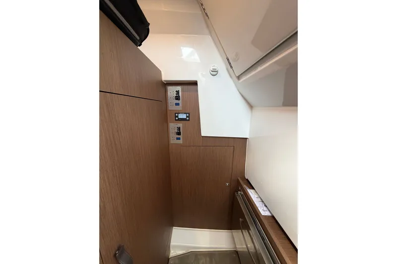 Slide: The Image of 2023 Beneteau Antares 11 OB interior with wood paneling and control panels. - 64