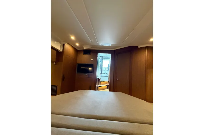 Slide: The Image of Interior cabin of 2023 Beneteau Antares 11 OB, featuring cozy bed and modern amenities. - 60