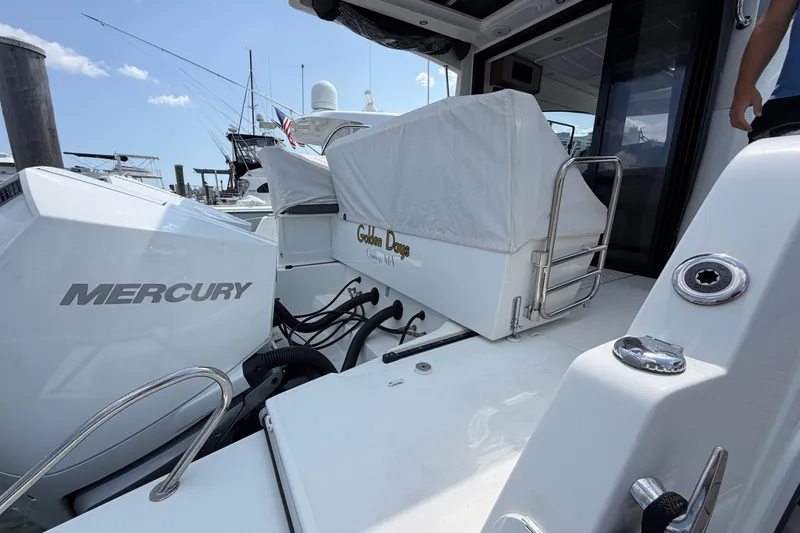 Slide: The Image of 2023 Beneteau Antares 11 OB boat with Mercury engine, docked under clear skies. - 92
