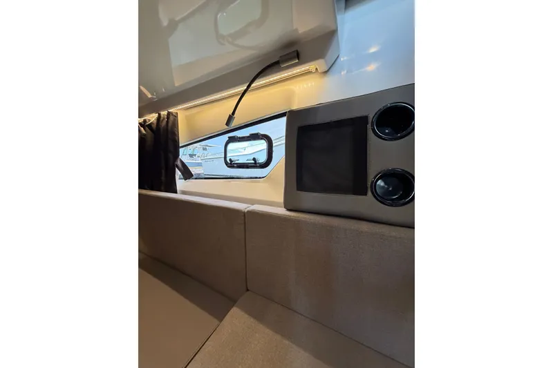 Slide: The Image of Interior view of 2023 Beneteau Antares 11 OB, featuring modern design and window detail. - 76