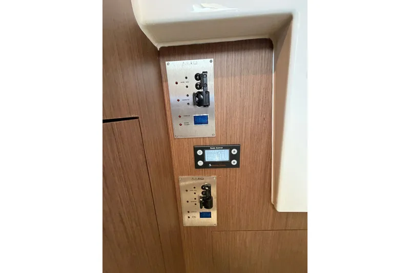 Slide: The Image of Control panel on 2023 Beneteau Antares 11 OB boat, featuring switches and digital display. - 70