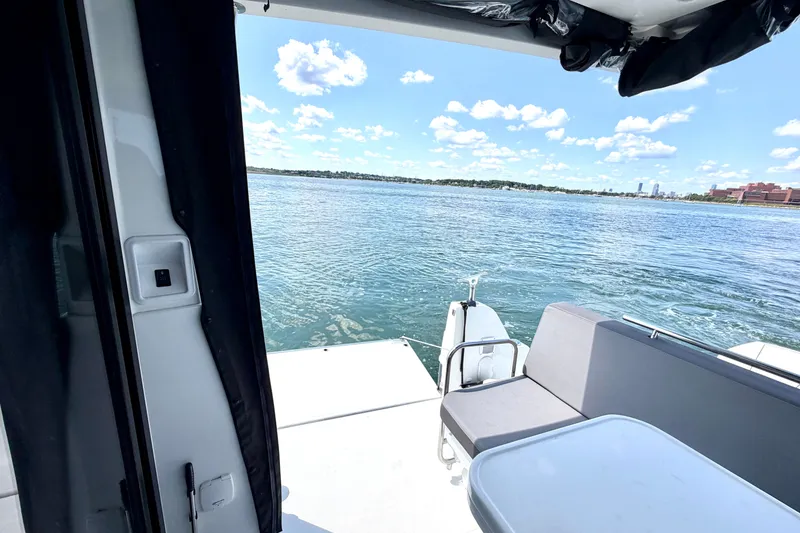 Slide: The Image of 2023 Beneteau Antares 11 OB boat interior with ocean view and seating area. - 34
