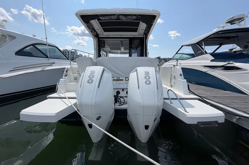 Slide: The Image of 2023 Beneteau Antares 11 OB with dual 300 HP engines docked at marina. - 14