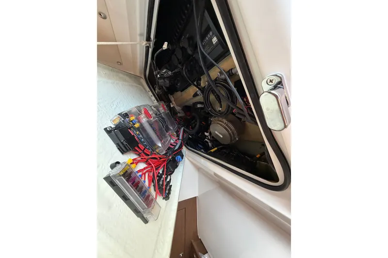 Slide: The Image of Electrical system inside a 2023 Beneteau Antares 11 OB boat, showcasing wiring and components. - 69