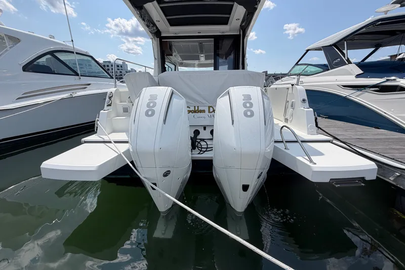 Slide: The Image of 2023 Beneteau Antares 11 OB with twin 300 horsepower engines docked at marina. - 95