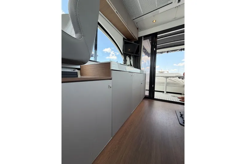 Slide: The Image of Interior view of 2023 Beneteau Antares 11 OB yacht, featuring sleek cabinetry and outdoor access. - 78