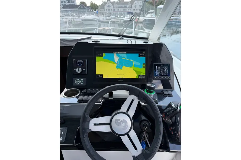 Slide: The Image of Cockpit view of 2023 Beneteau Antares 11 OB with navigation display and controls. - 47