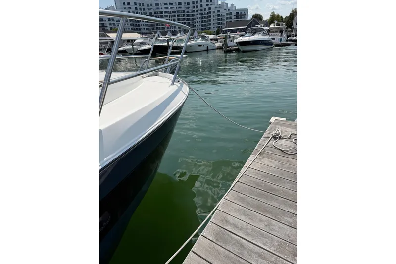 Slide: The Image of 2023 Beneteau Antares 11 OB docked at marina with other boats. - 11