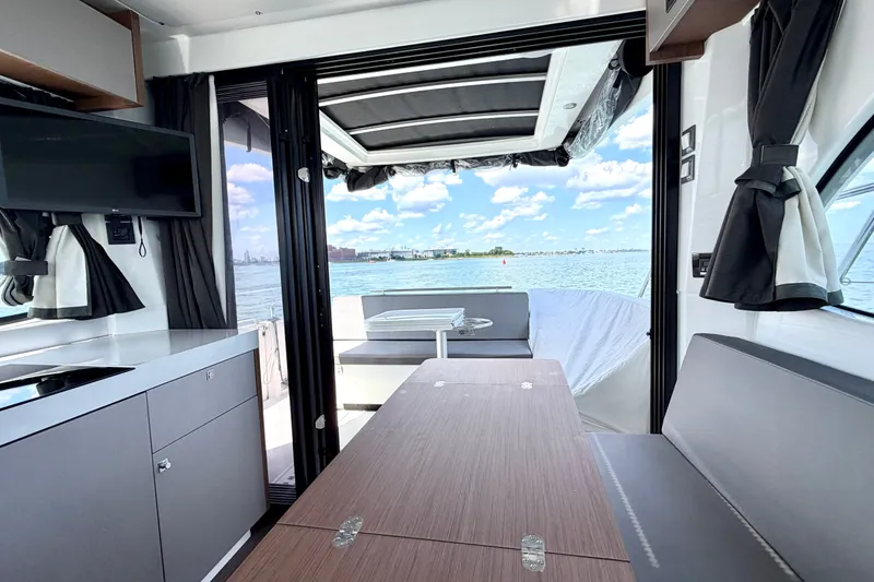 Slide: The Image of Interior view of 2023 Beneteau Antares 11 OB yacht, featuring modern design and waterfront scenery. - 37