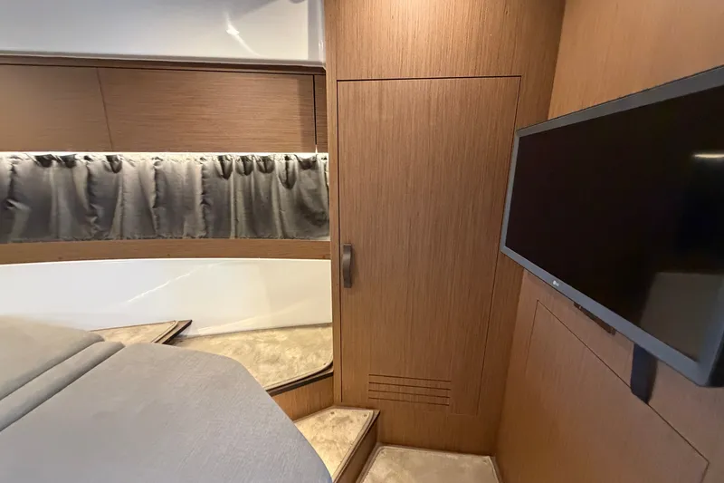 Slide: The Image of Interior cabin of 2023 Beneteau Antares 11 OB with wood paneling and mounted TV. - 58