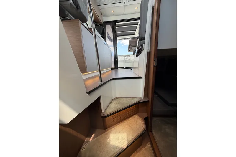 Slide: The Image of Interior stairs of 2023 Beneteau Antares 11 OB yacht, featuring modern design and wood accents. - 83