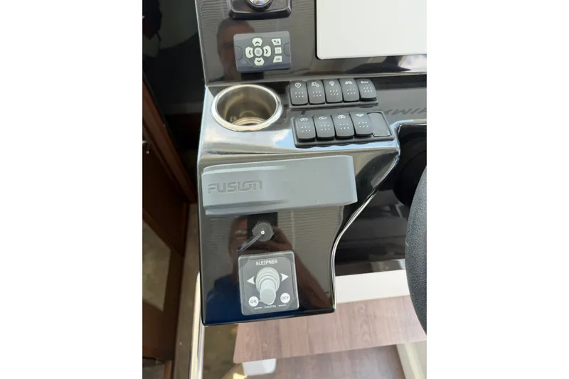 Slide: The Image of Control panel of 2023 Beneteau Antares 11 OB with buttons and Fusion audio system. - 45