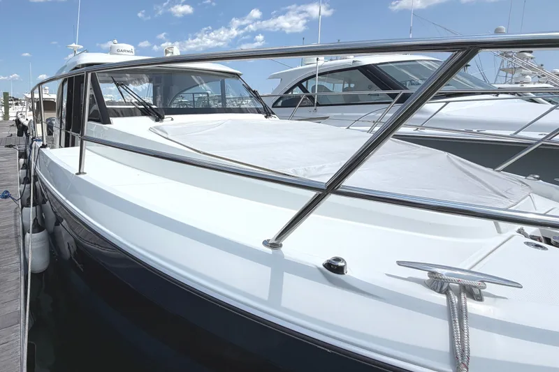 Slide: The Image of 2023 Beneteau Antares 11 OB docked under a clear blue sky. - 5