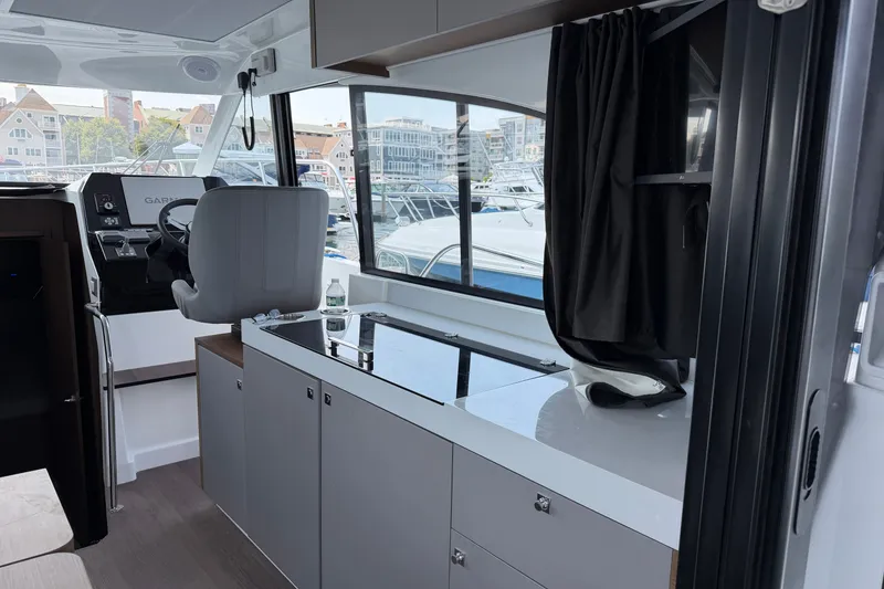 Slide: The Image of Interior of 2023 Beneteau Antares 11 OB boat with helm and kitchenette. - 17