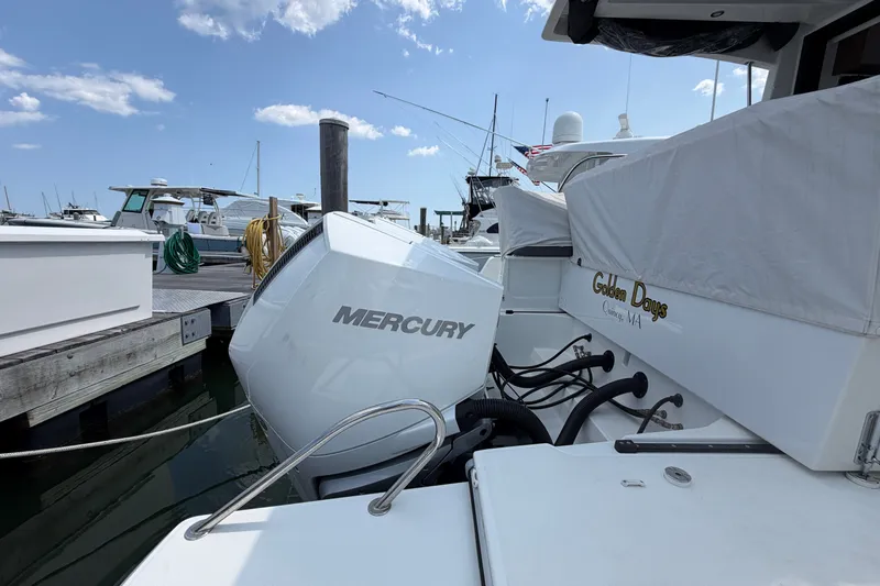 Slide: The Image of 2023 Beneteau Antares 11 OB with Mercury outboard engine docked at marina. - 97